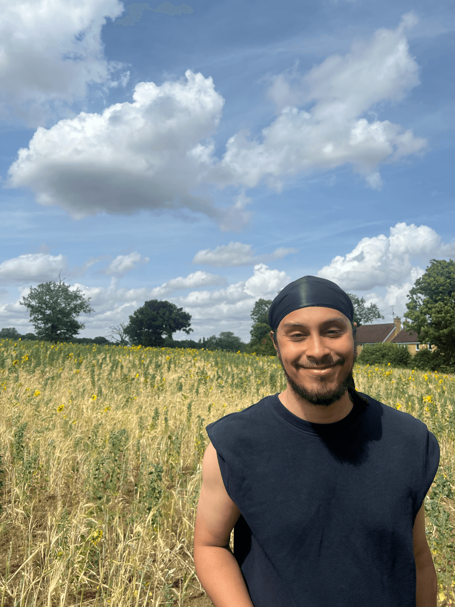 Alex Donovan-Lowe, founder of Black Stacks, standing in a field
